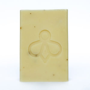 Lavender and Aloe Vera Soap - A soft white bar with black speckles, featuring our bee imprint, displayed against a clean white background. Immerse yourself in the soothing aroma of lavender.
