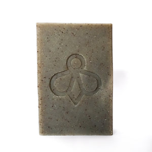 Worker Bee Scrubby Soap - Featuring our bee logo imprint on a charcoal-coloured bar, displayed against a clean white background.